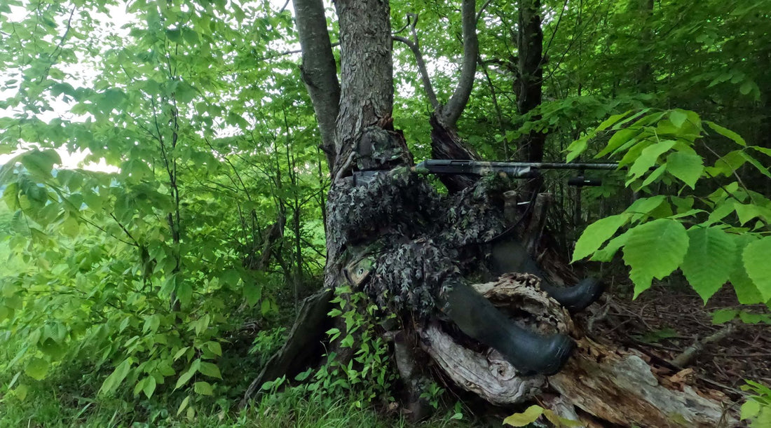 mossy oak leafy camo gear worn by hunter in the woods