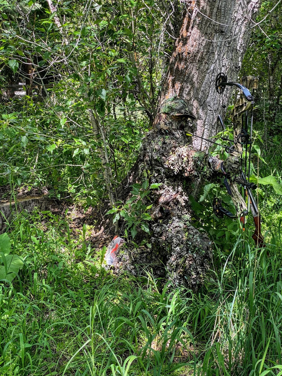 The hunter reveals his position in tall grass
